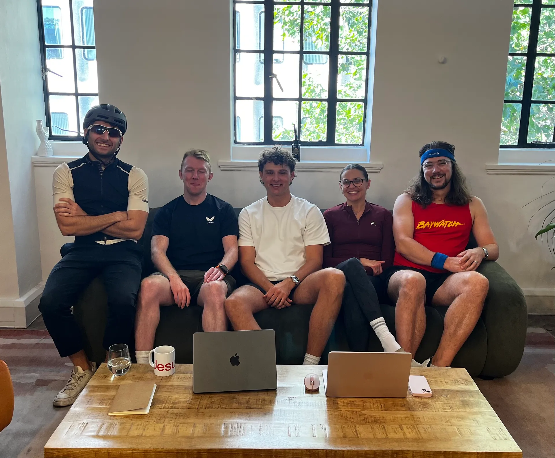 Motion team in exercise gear sat down on a sofa at Motion HQ